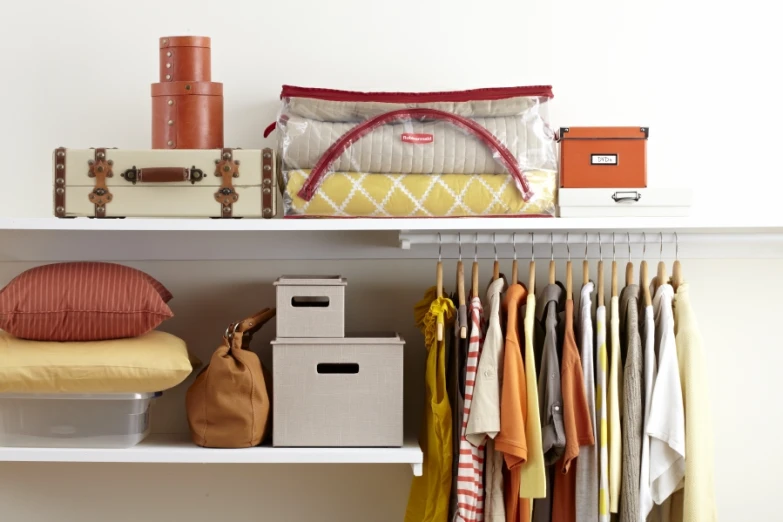 a small closet with clothes and handbags