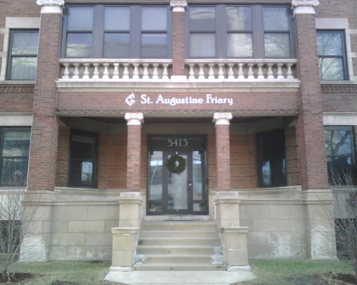 a building with a door and steps leading to the front door