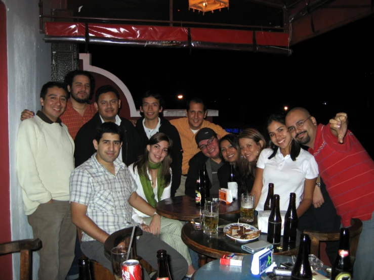 a large group of people smile while sitting around