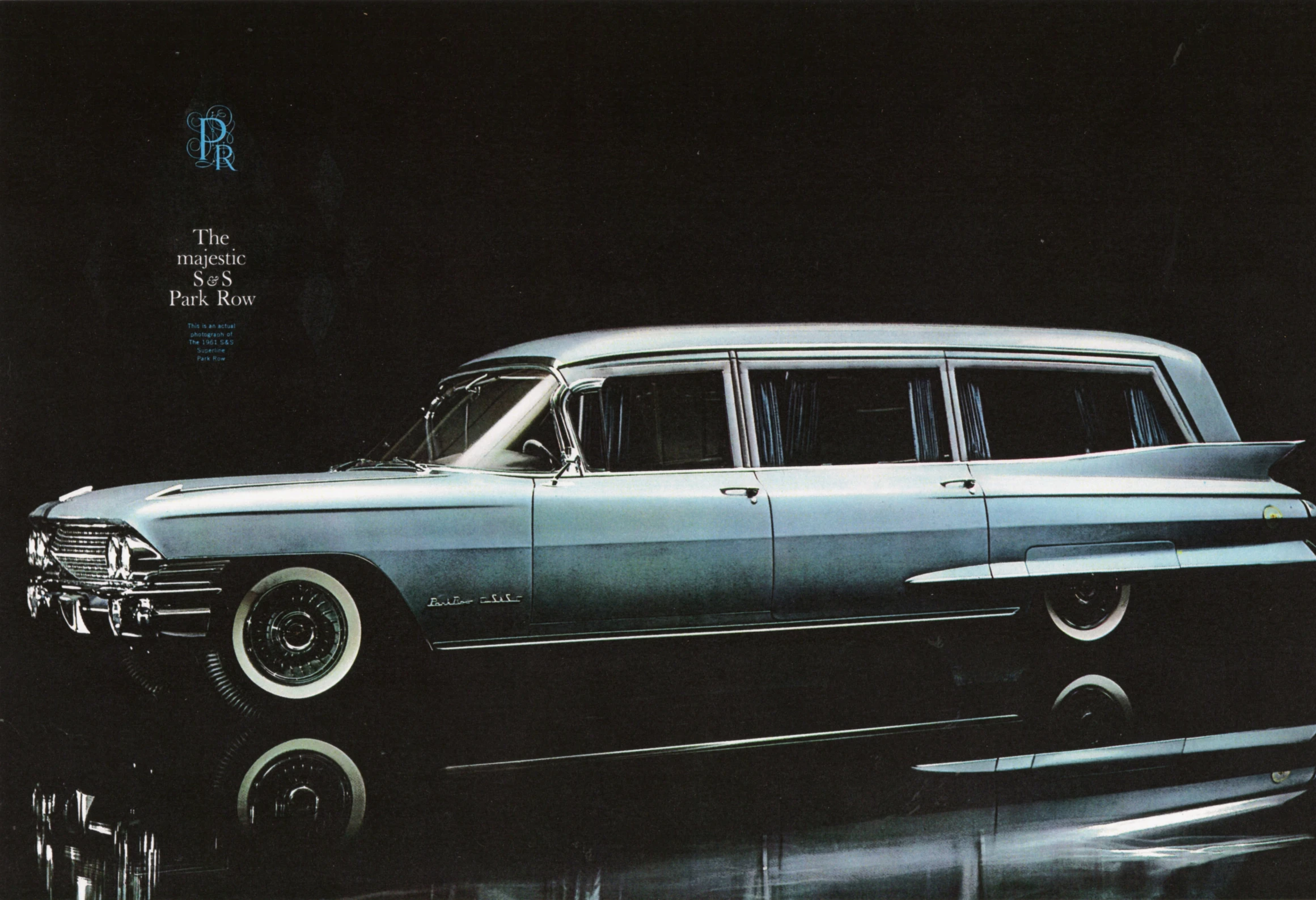 a vintage car sits parked on the shiny floor