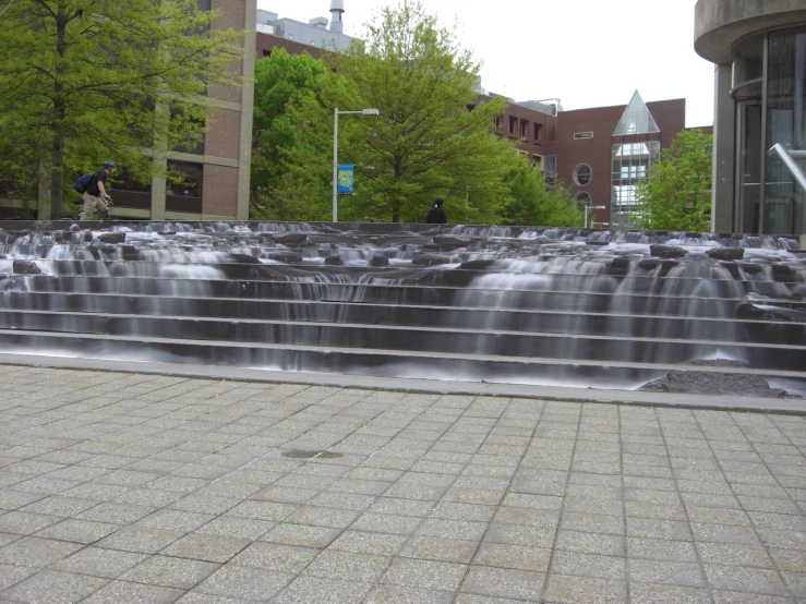 a man is on a stairway near a waterfall