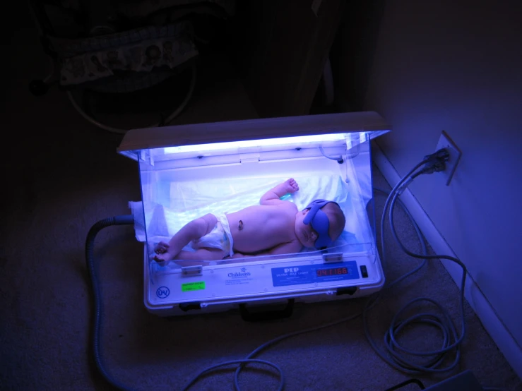 a baby laying on a scale in the middle of a room