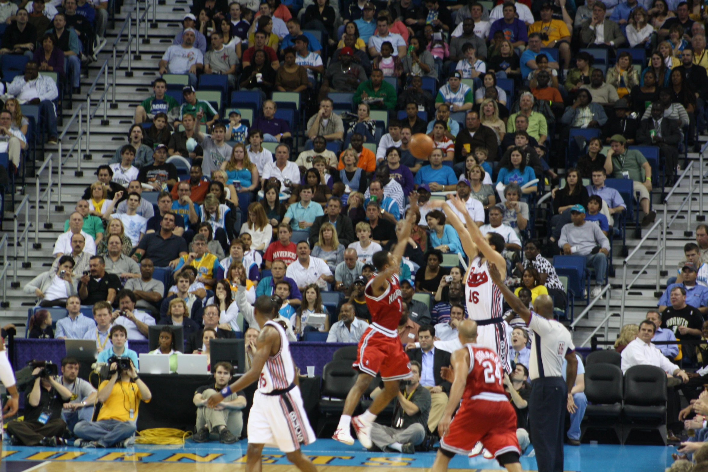 two teams playing in a basketball game at the court