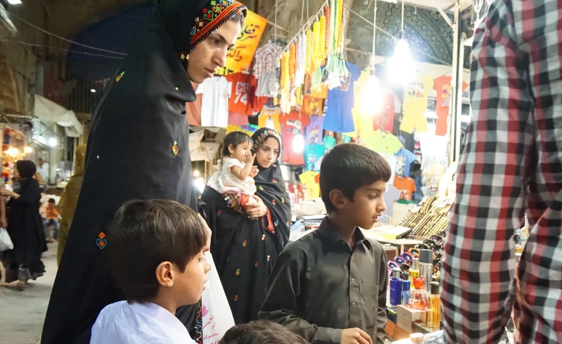 an outdoor market with lots of food and people