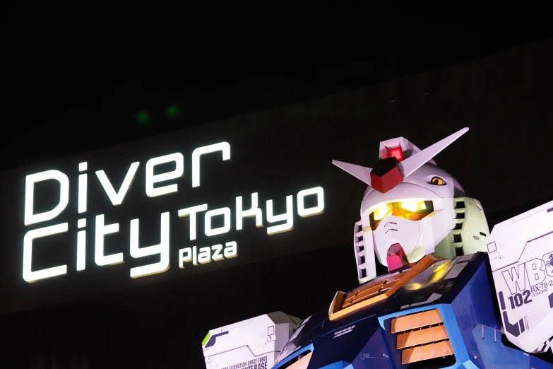 a building with a huge sign that reads diver city tokyo next to it