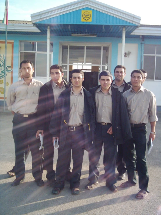 several men are standing in front of a building