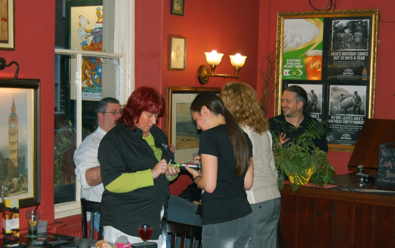 a group of people gathered at the bar in the lobby