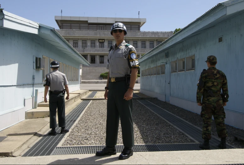 a military man in uniform talking on the street