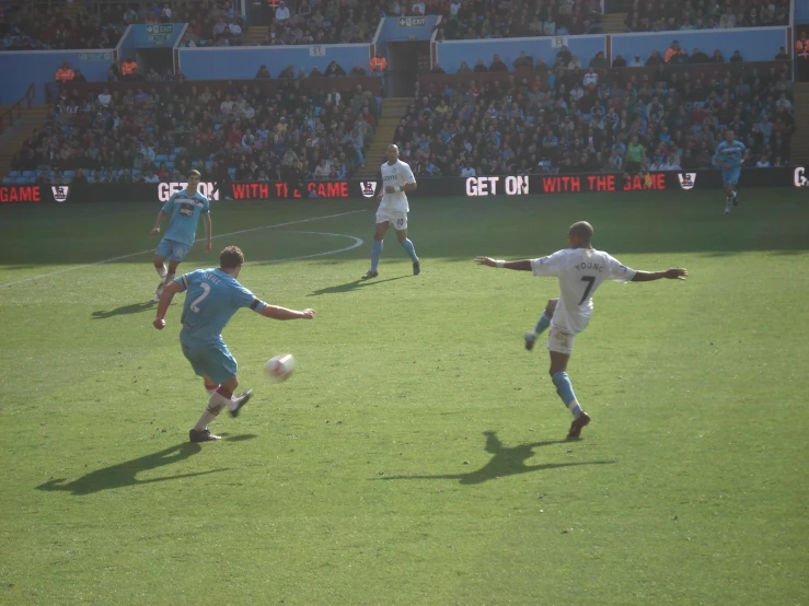 three soccer players are on a soccer field