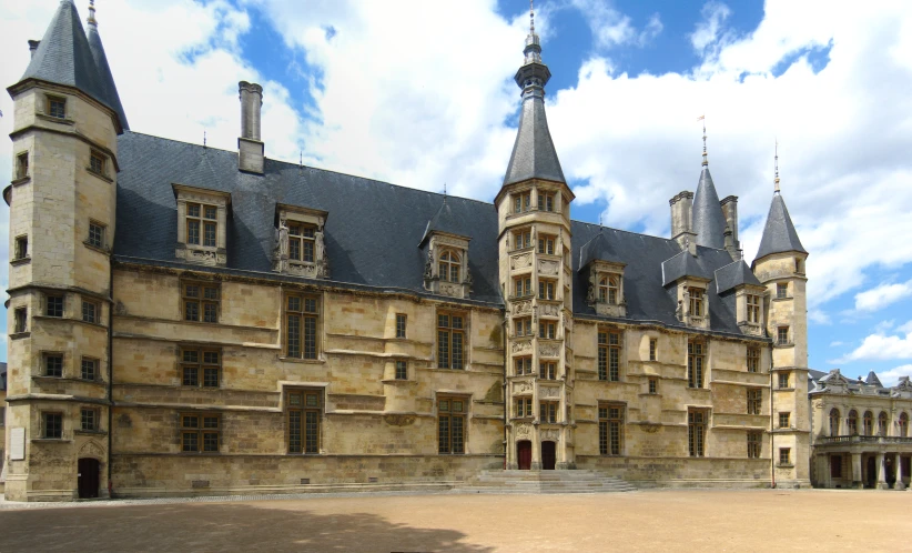 a building with a tower and a black roof