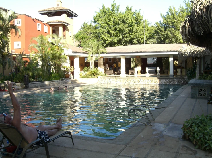 someone relaxing in a chair at the end of a swimming pool