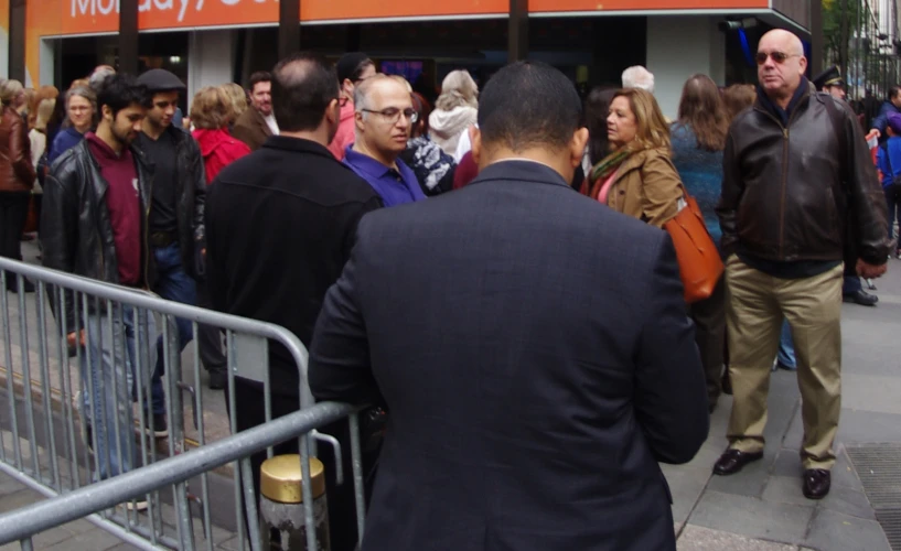 a group of people waiting at a gate