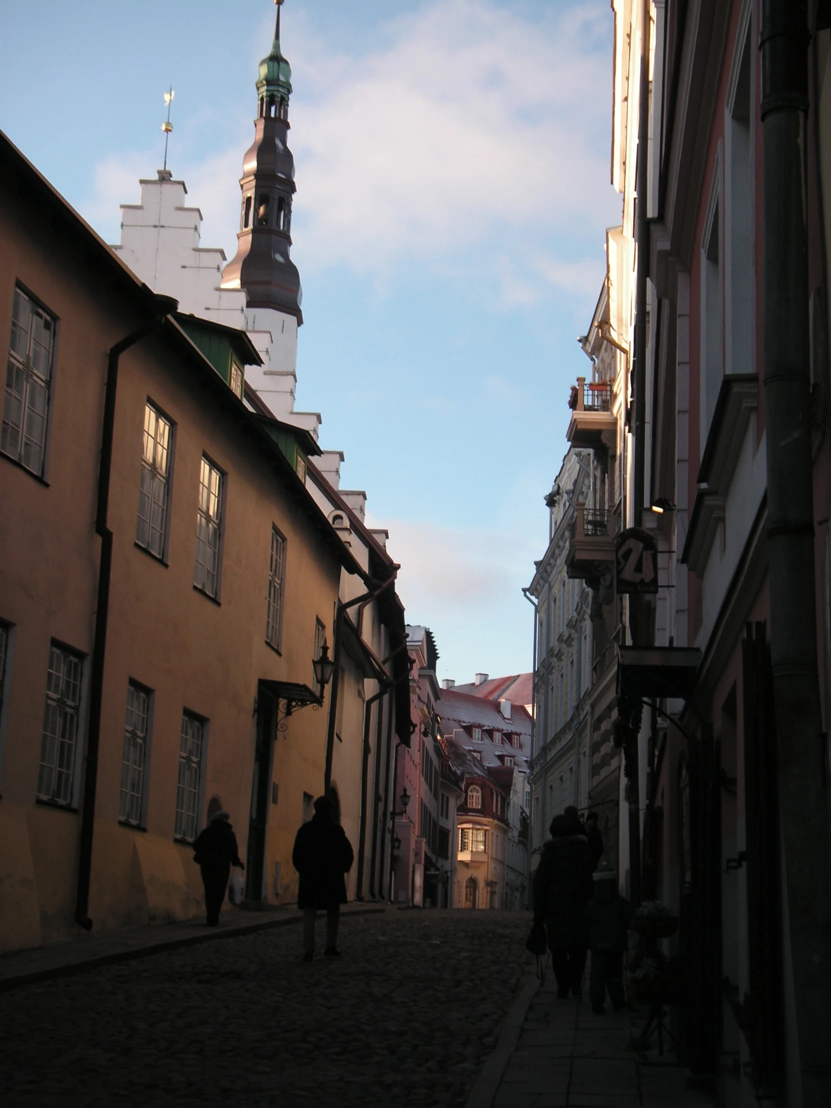 some people are walking on a cobblestone street