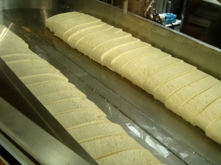 long flat bread is prepared in a machine