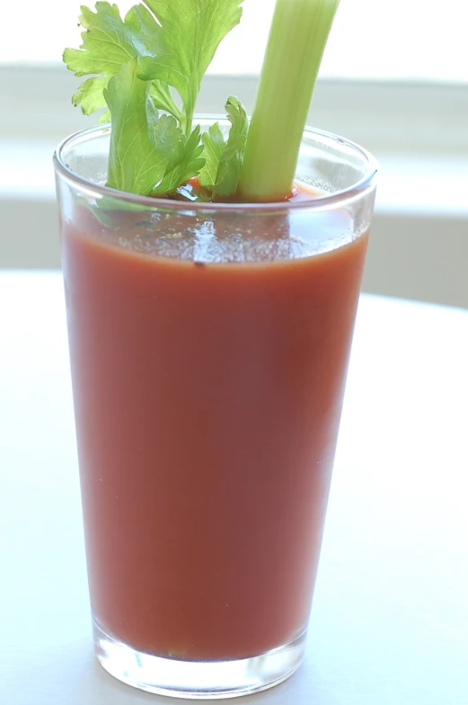 the glass holds a green celery on top