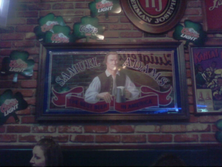 a man in a vest and red tie in front of a framed pograph