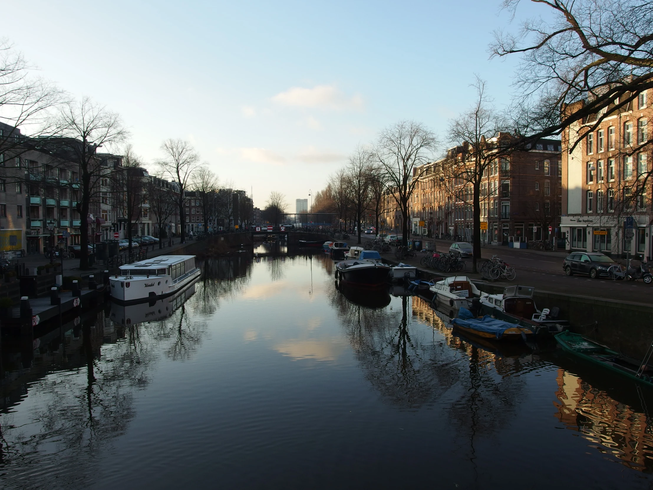 a small river that has lots of boats floating in it