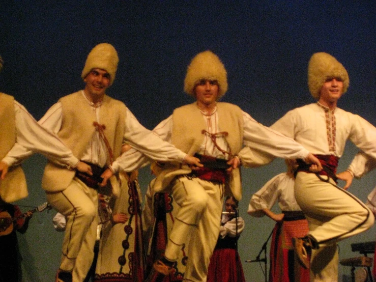 a group of people are on stage wearing costume