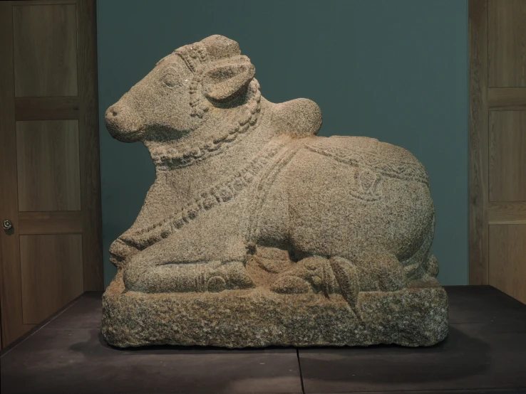 a sculpture of a dog sitting in the corner