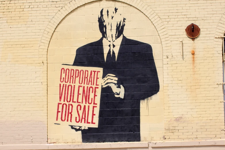 a mural of a man with his head in a mask and holding a paper