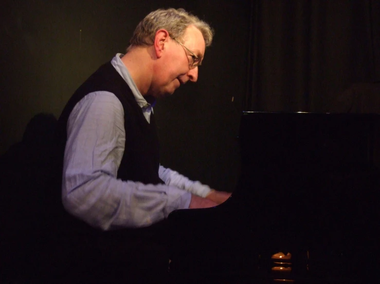 a man is playing the piano at a party