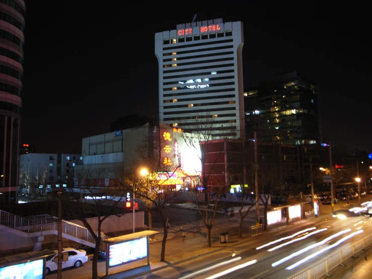 a street with cars and a large building