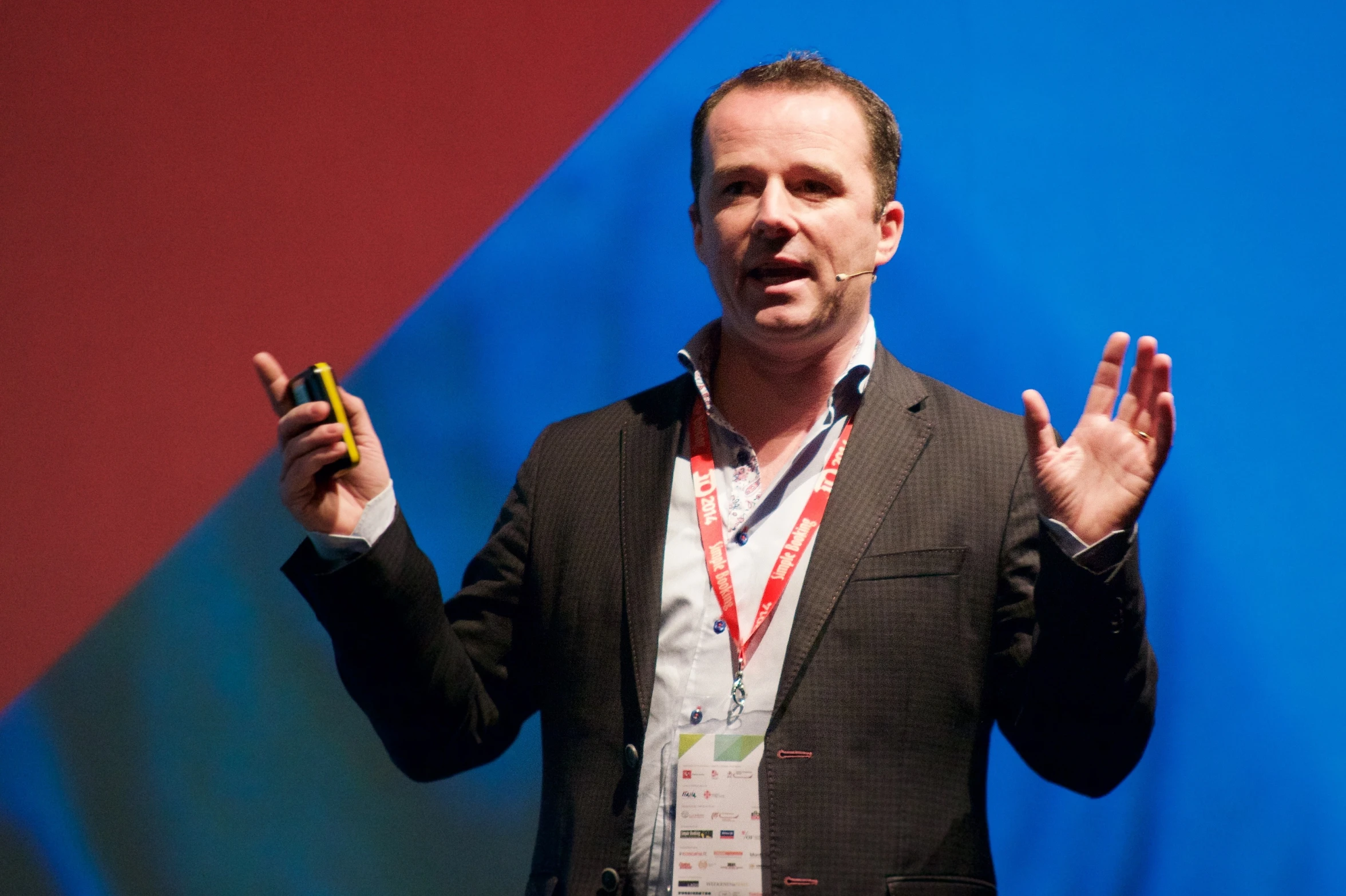 a man holding his hands up while talking