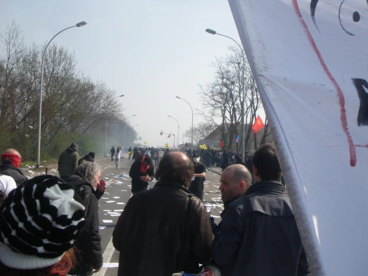 many people walking on the street near street signs