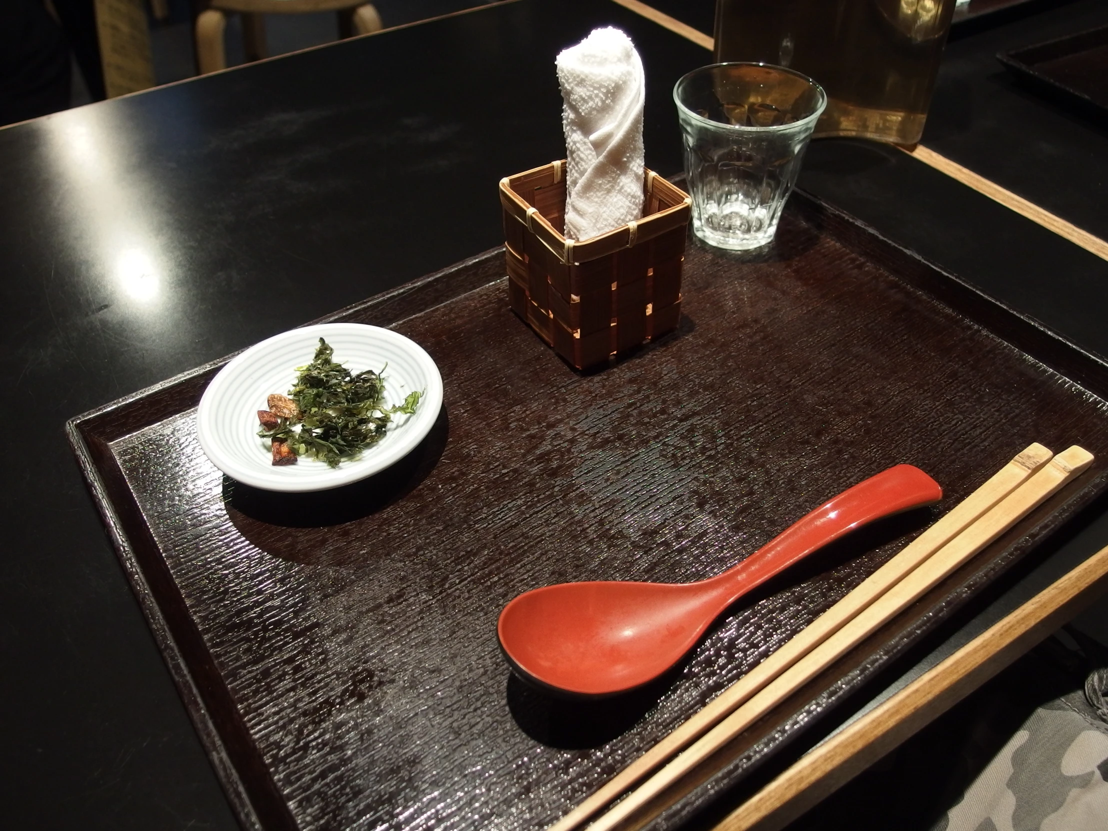 a table with chopsticks, a plate and another dish on it