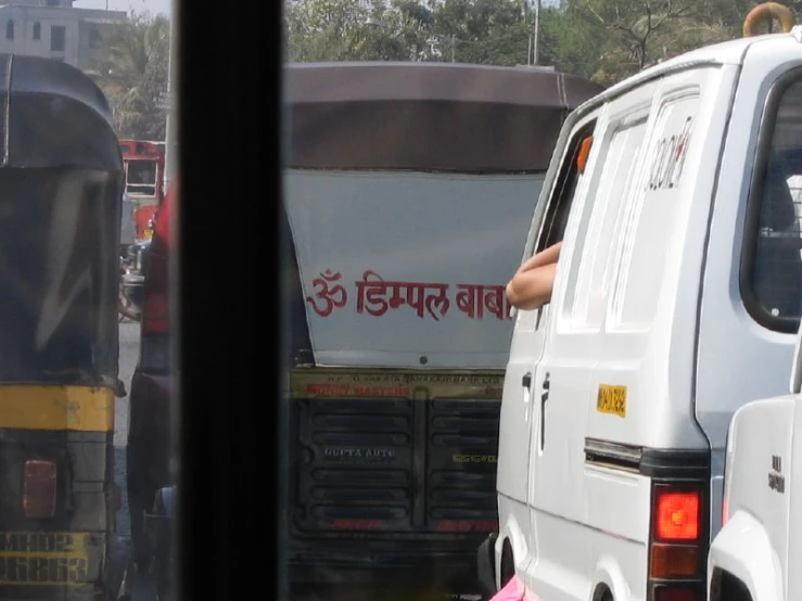 a person sits on the back of a bus in the street