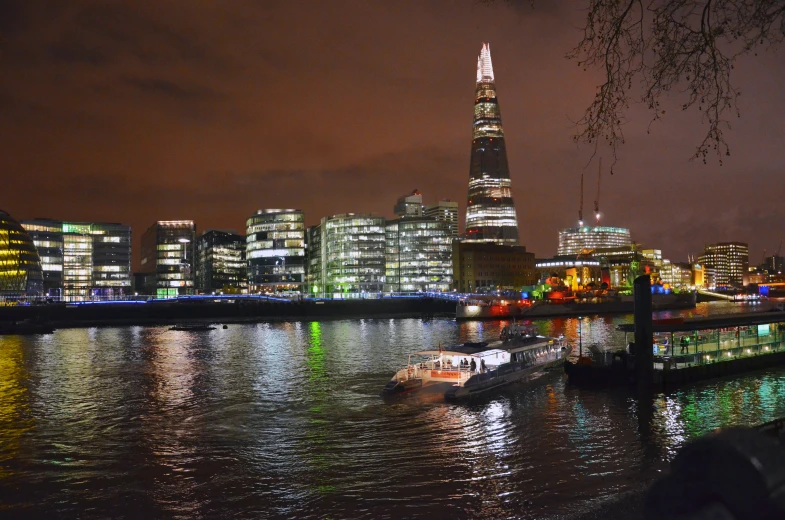 a boat on the water at night in the city