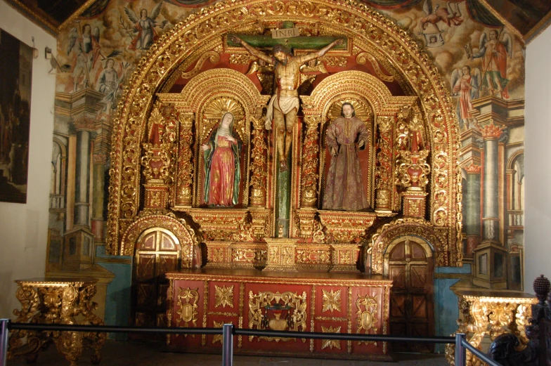 an elaborately decorated, gilded gold alter in a church