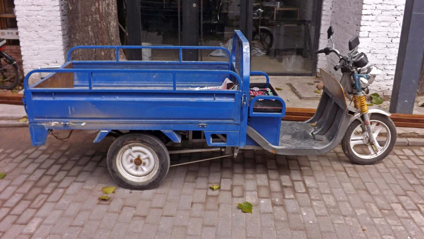 a blue motorcycle is parked in front of a building