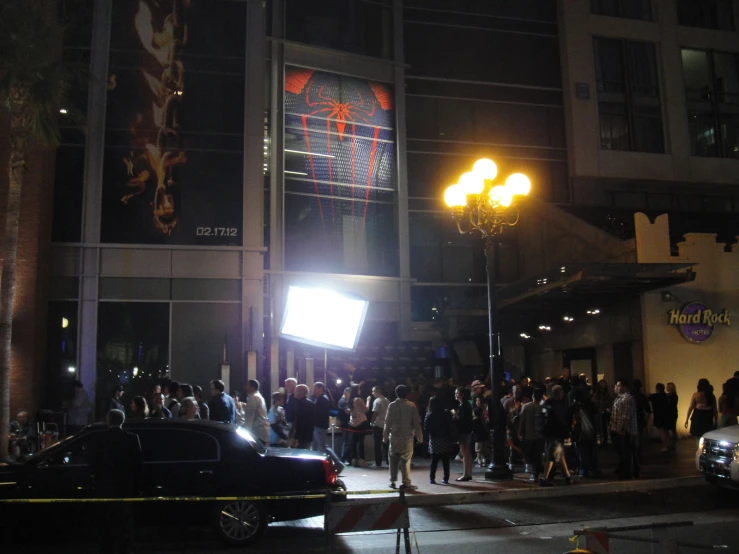 large crowd on the side of a building at night