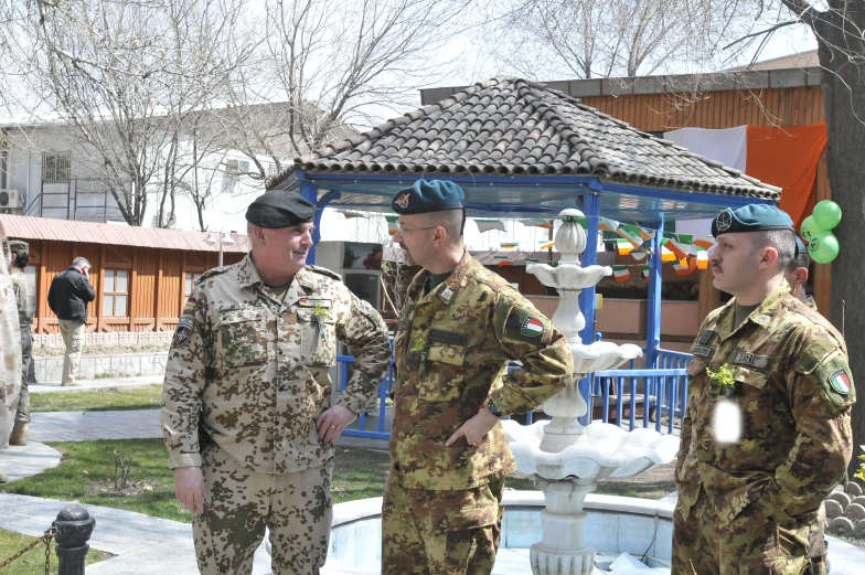 military men are standing in front of a fountain