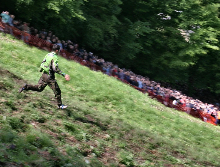 people are watching a man that is flying a kite