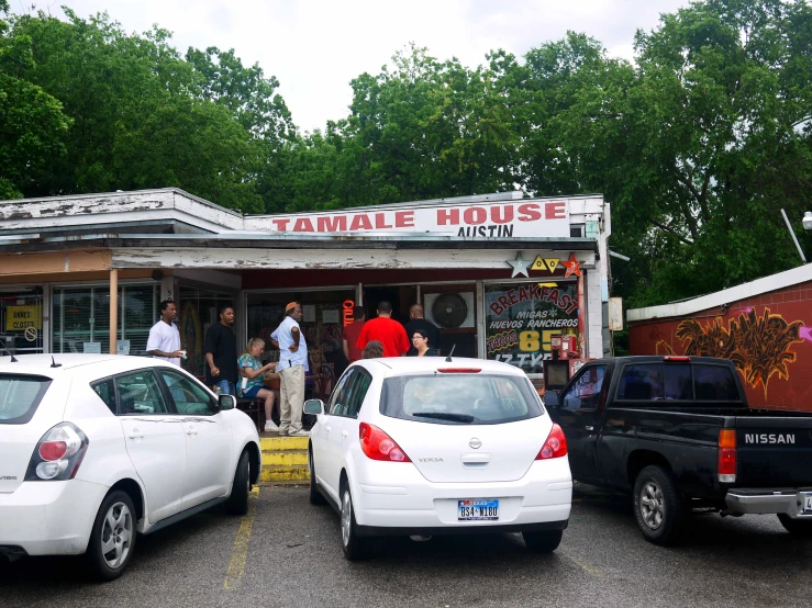 cars are parked outside of a doughnut house