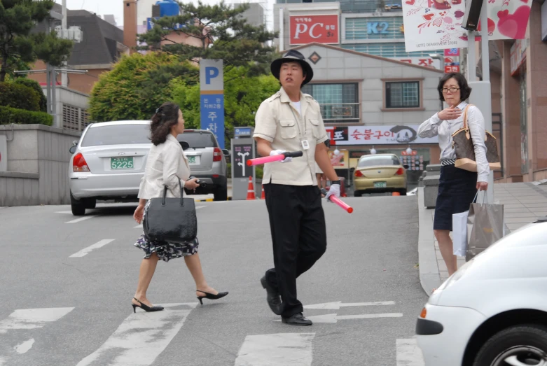 two asian people are walking with a woman and her son