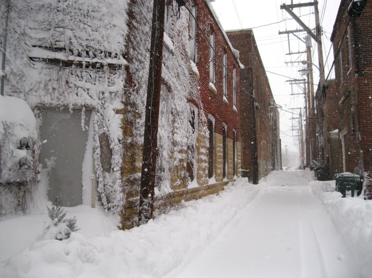 an alley lined with snowy buildings in winter