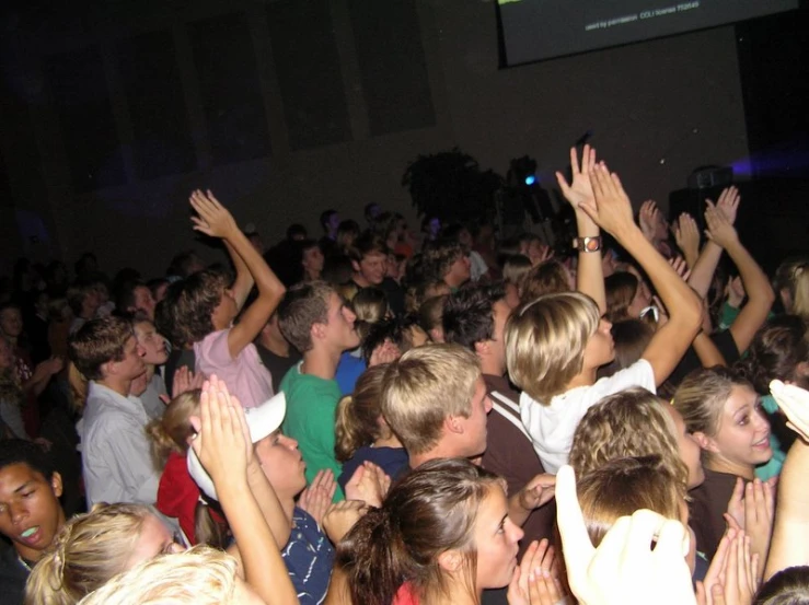 a large group of people stand together at the dance