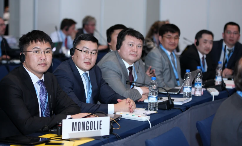 a panel meeting with two men sitting in front of them