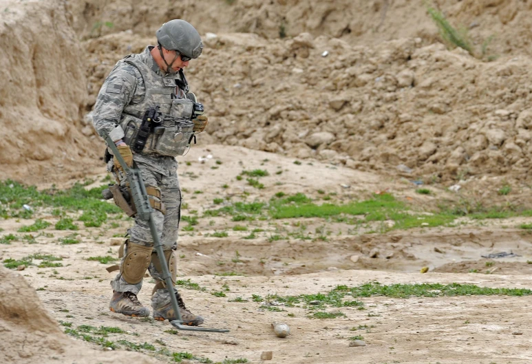 a soldier is standing in the dirt