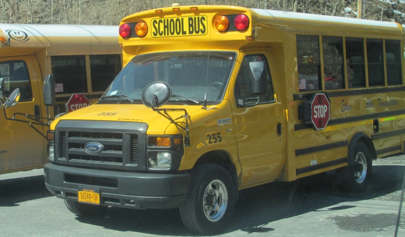 two yellow school buses parked next to each other