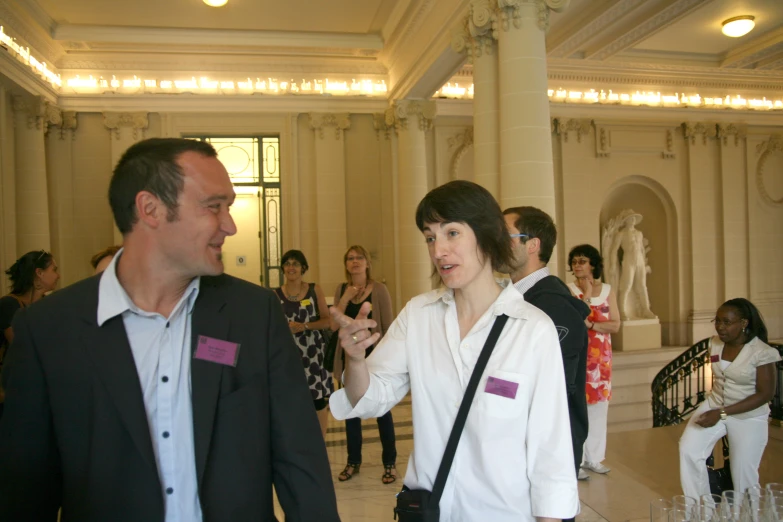 a man and a woman talk at a party