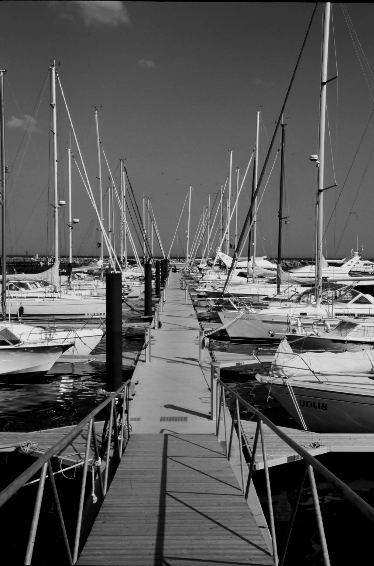 a dock filled with lots of boats in the water