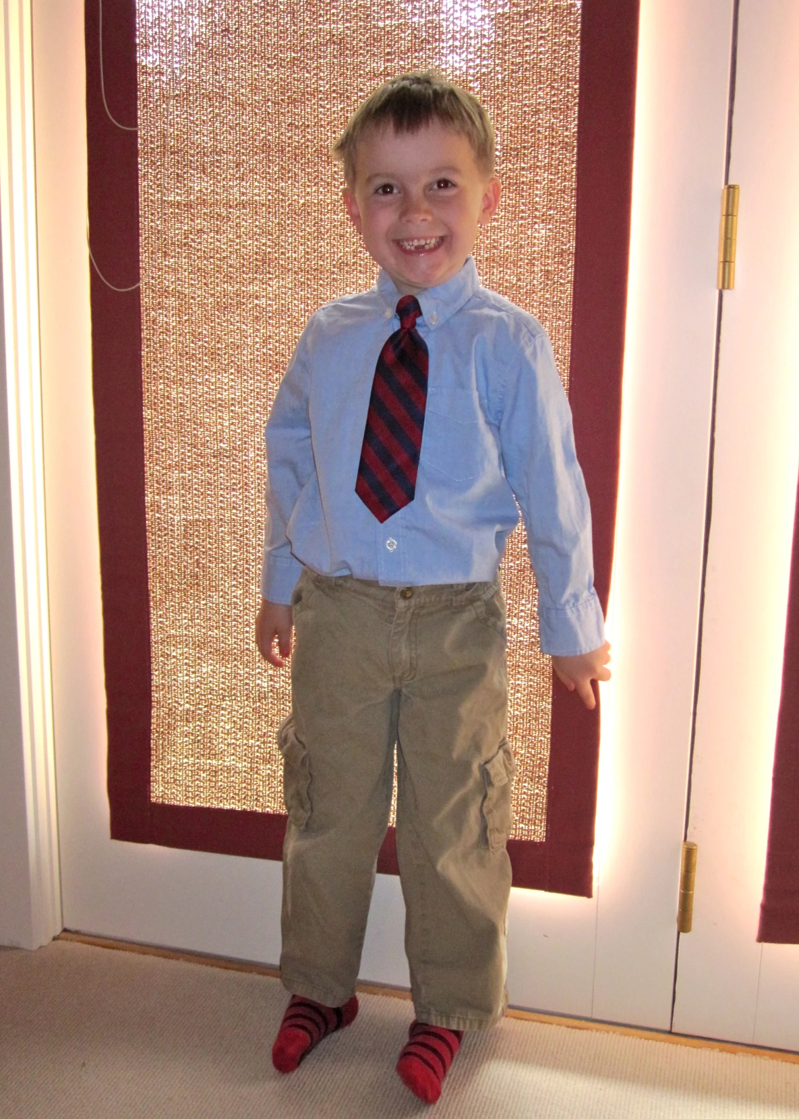 a little boy in a dress shirt and tie