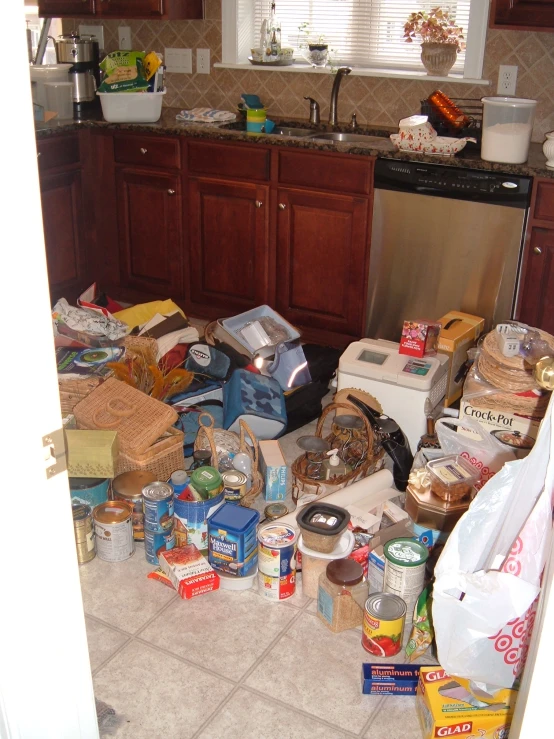 a mess inside a kitchen with appliances and food