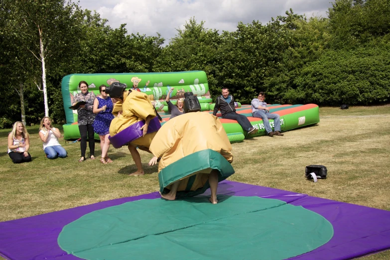 three people practicing yoga in an outdoor park