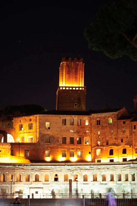 the buildings in this city are lit up with yellow lights