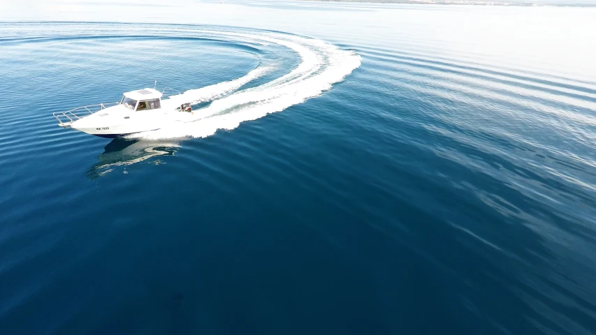 a small boat sailing in the open blue water